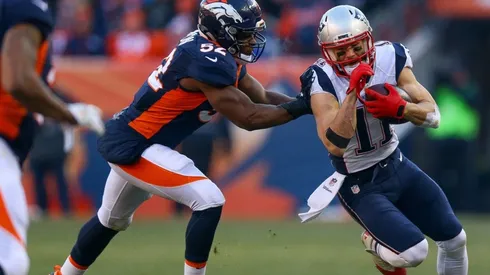 Julian Edelman getting past the Broncos' defense. (Getty)