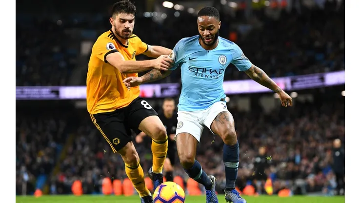 Raheem Sterling of Manchester City (right) is tackled by Ruben Neves of Wolverhampton Wanderers (left). (Getty)