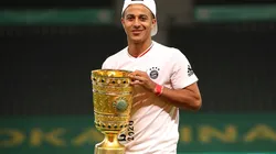 Thiago Alcantara of FC Bayern Muenchen poses with the trophy in celebration after the DFB Cup
