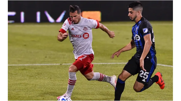 Toronto FC's Pablo Piatti gets past Emanuel Maciel of Montreal Impact. (Getty)