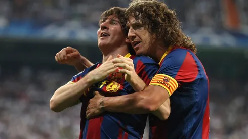 Carles Puyol and Lionel Messi as Barcelona teammates (Getty).