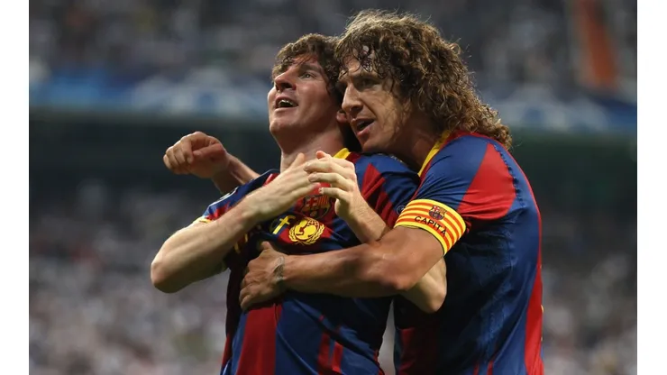 Carles Puyol and Lionel Messi as Barcelona teammates (Getty).