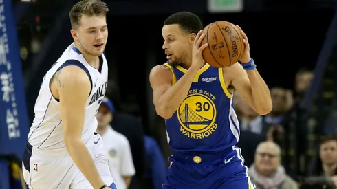 Luka Doncic (left) guarding Stephen Curry. (Getty)