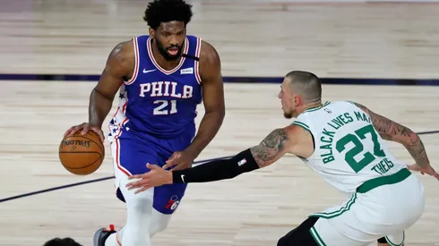 Joel Embiid dribbling past Daniel Theis. (Getty)