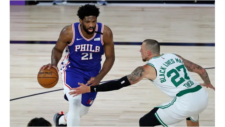Joel Embiid dribbling past Daniel Theis. (Getty)