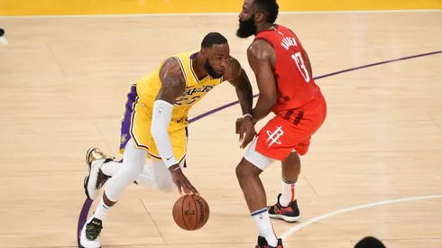 LeBron James dribbling past James Harden. (Getty)