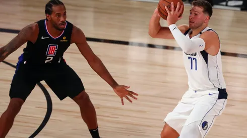 Luka Doncic (right) has scored 70 points through the first 2 games. (Getty)