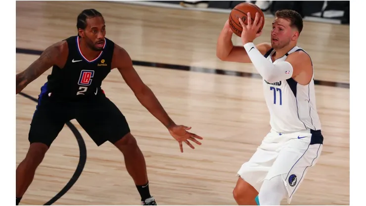 Luka Doncic (right) has scored 70 points through the first 2 games. (Getty)