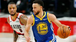 Stephen Curry dribbles past Damian Lillard. (Getty)