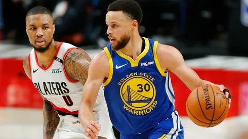 Stephen Curry dribbles past Damian Lillard. (Getty)