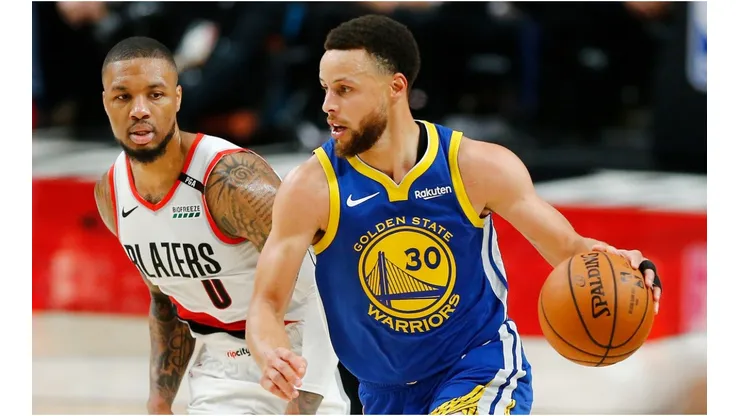 Stephen Curry dribbles past Damian Lillard. (Getty)