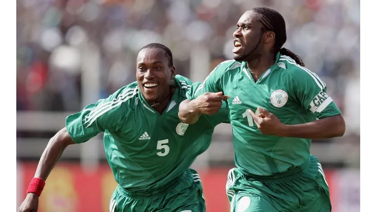 Jay-Jay Okocha (right) of Nigeria celebrates his goal with Chidi Odiah during the 2006 World Cup Qualifying match against Angola (Getty).