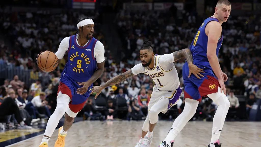 Kentavious Caldwell-Pope #5 of the Denver Nuggets drives against D’Angelo Russell #1 of the Los Angeles Lakers on a pick by Nikola Jokic #15 in the third quarter during game one of the Western Conference First Round Playoffs at Ball Arena.  (Photo by Matthew Stockman/Getty Images)