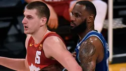 Nikola Jokic #15 of the Denver Nuggets is guarded by LeBron James #23 of the Los Angeles Lakers during the first half at Staples Center.