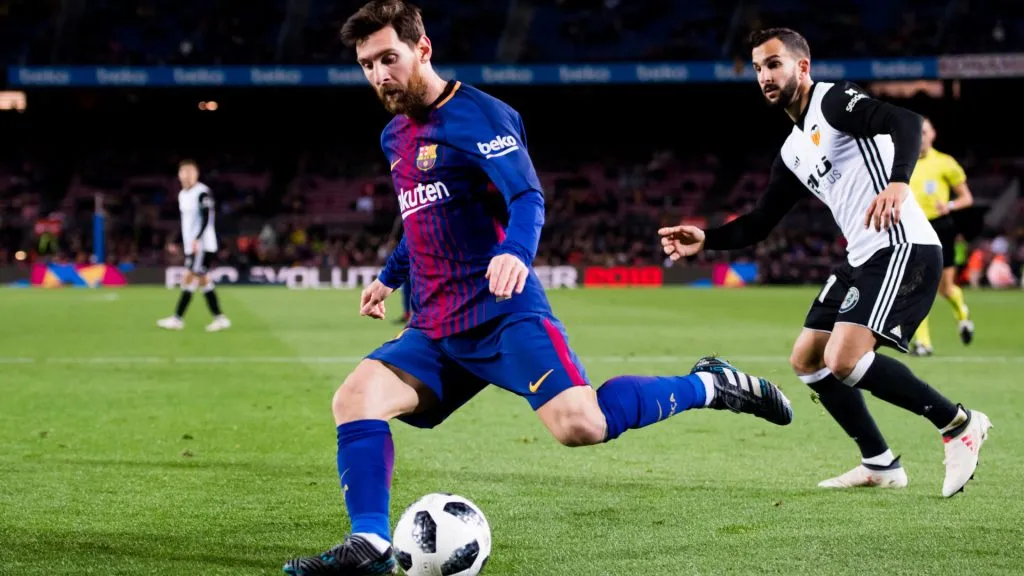 Lionel Messi of FC Barcelona assists his teammate Luis Suarez to score the opening goal during the Copa del Rey semi-final first leg match between FC Barcelona and Valencia CF. Alex Caparros/Getty Images