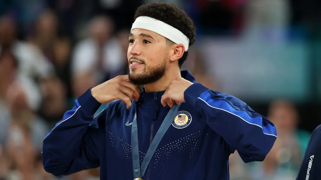 Gold medalists Devin Booker of Team United States looks on from the podium during the Men’s basketball medal ceremony. Gregory Shamus/Getty Images