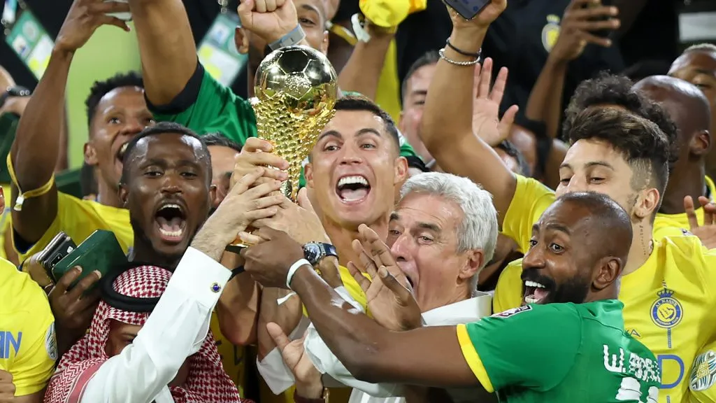 Cristiano Ronaldo of Al Nassr lifts the Arab Club Champions Cup trophy with teammates after the team’s victory in the Arab Club Champions Cup Final. Yasser Bakhsh/Getty Images