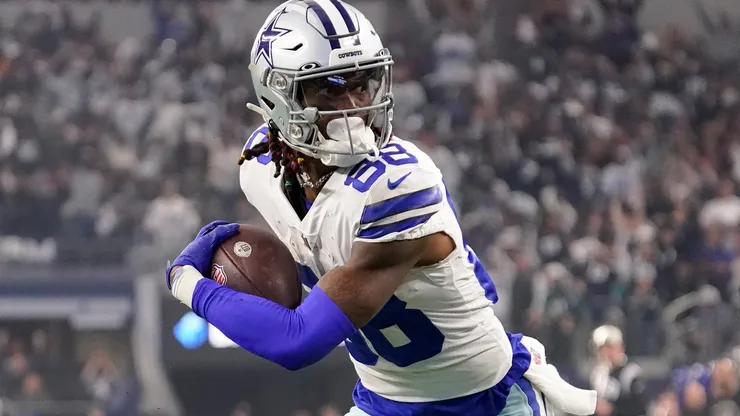 CeeDee Lamb #88 of the Dallas Cowboys carries the ball for a touchdown against the Philadelphia Eagles during the second quarter at AT&T Stadium on December 24, 2022 in Arlington, Texas.