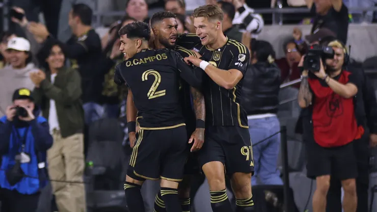 Denis Bouanga celebrates with his teammates.