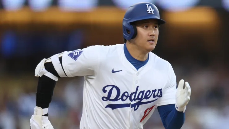 Shohei Ohtani #17 of the Los Angeles Dodgers runs to first on a ground out during the first inning against the Philadelphia Phillies at Dodger Stadium on August 07, 2024 in Los Angeles, California.