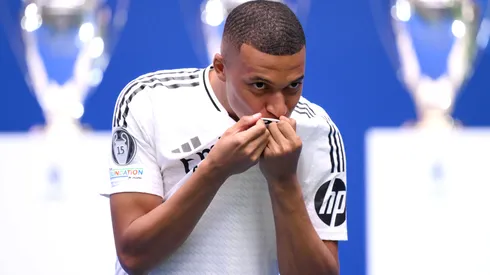 Real Madrid new signing, Kylian Mbappe kisses the Real Madrid badge as he is unveiled at Estadio Santiago Bernabeu on July 16, 2024 in Madrid, Spain.