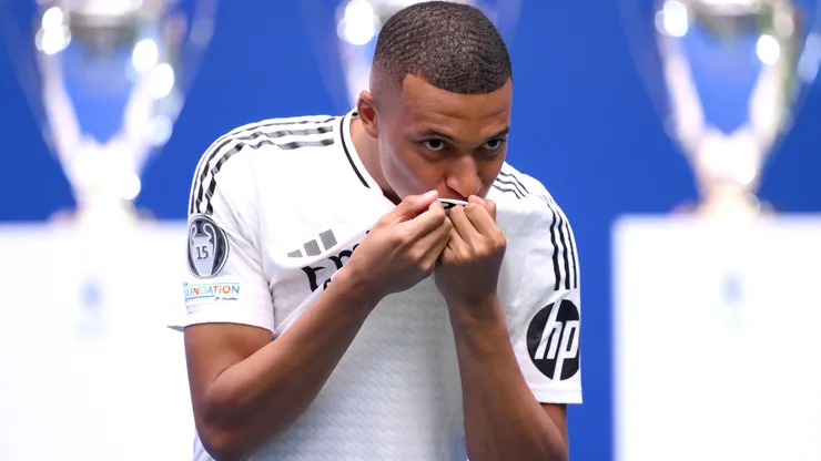 Real Madrid new signing, Kylian Mbappe kisses the Real Madrid badge as he is unveiled at Estadio Santiago Bernabeu on July 16, 2024 in Madrid, Spain.