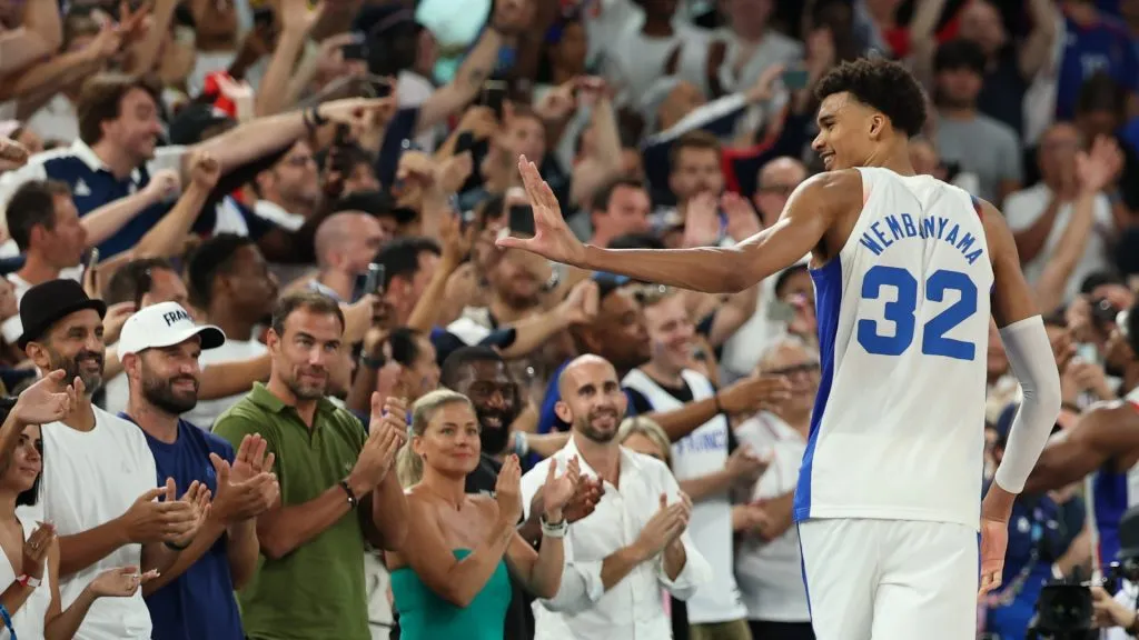 French fans cheer as Victor Wembanyama #32 of Team France acknowledges the crowd after Team Franceās victory against Team Canada during a Menās basketball quarterfinal game between Team Canada and Team France on day eleven of the Olympic Games Paris 2024 at Bercy Arena on August 06, 2024 in Paris, France. (Photo by Jamie Squire/Getty Images)