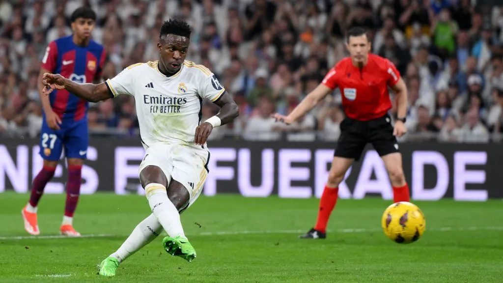 Vinicius Junior of Real Madrid scores his team's first goal from the penalty spot during the LaLiga EA Sports match between Real Madrid CF and FC Barcelona at Estadio Santiago Bernabeu on April 21, 2024 in Madrid, Spain.