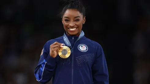 Gold medalist Simone Biles of Team United States celebrates on the podium during the medal ceremony for the Artistic Gymnastics Women's Vault Final on day eight of the Olympic Games Paris 2024 at Bercy Arena on August 03, 2024 in Paris, France.