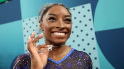 Gold medalist Simone Biles of Team United States poses with a necklace in the likeness of a goat after competing in the Artistic Gymnastics Women's All-Around Final.