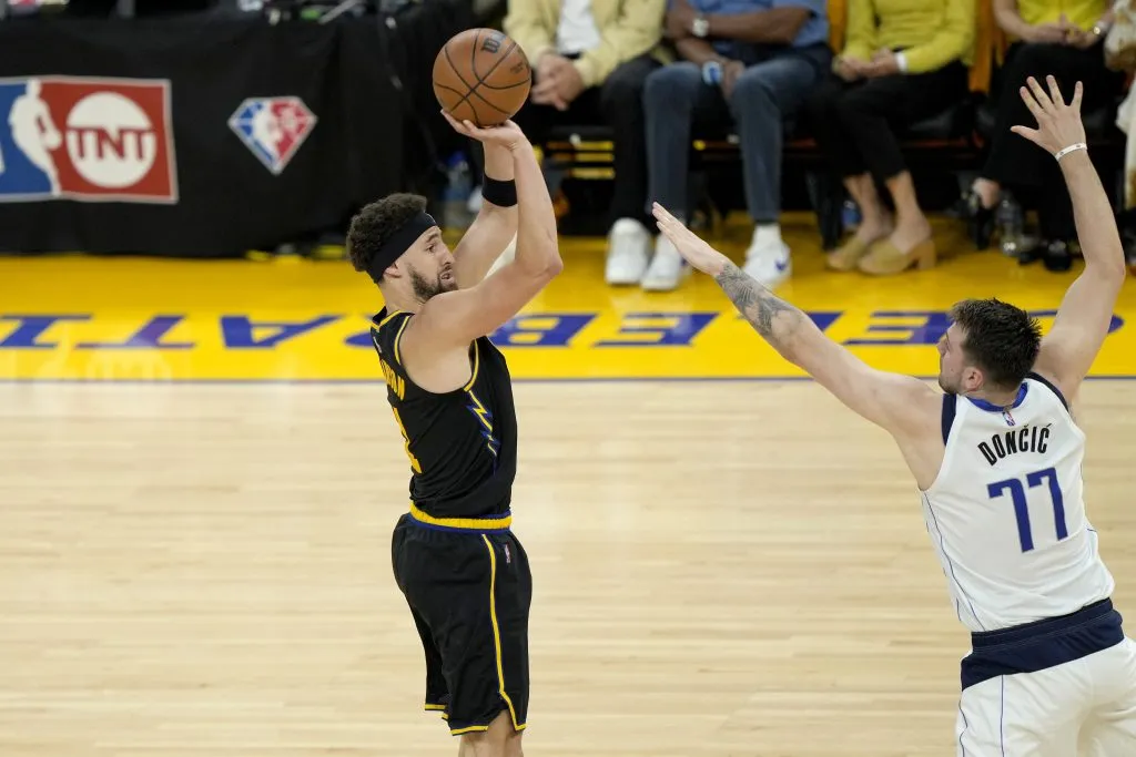 Klay Thompson #11 of the Golden State Warriors shoots the ball against Luka Doncic #77 of the Dallas Mavericks. Thearon W. Henderson/Getty Images