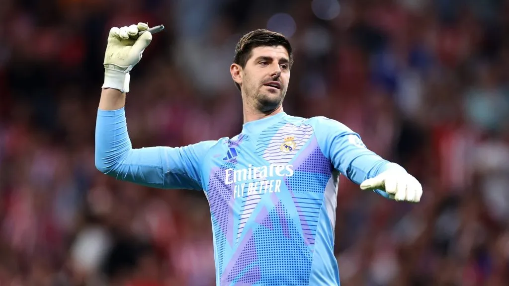 Thibaut Courtois of Real Madrid removes a cigarette lighter from the pitch during the LaLiga match between Atletico de Madrid and Real Madrid CF at Estadio Civitas Metropolitano on September 29, 2024 in Madrid, Spain. (Photo by Florencia Tan Jun/Getty Images)