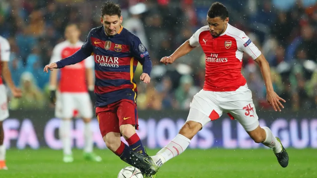Lionel Messi of Barcelona and Francis Coquelin of Arsenal compete for the ball during the UEFA Champions League round of 16, second Leg match between FC Barcelona and Arsenal FC at Camp Nou on March 16, 2016 in Barcelona, Spain.