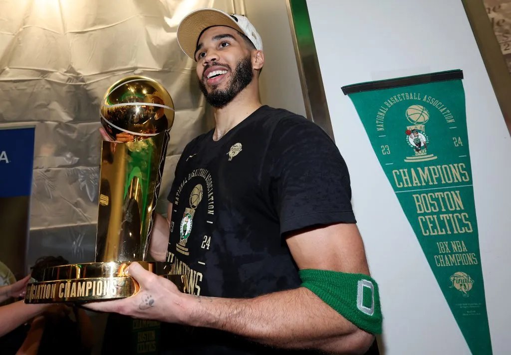 Jayson Tatum #0 of the Boston Celtics celebrate with the Larry O’Brien Championship Trophy. Elsa/Getty Images