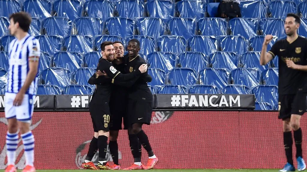Sergino Dest of FC Barcelona celebrates with Lionel Messi and Ousmane Dembele after scoring their side's second goal during the La Liga Santander match between Real Sociedad and FC Barcelona at Estadio Anoeta on March 21, 2021 in San Sebastian, Spain.