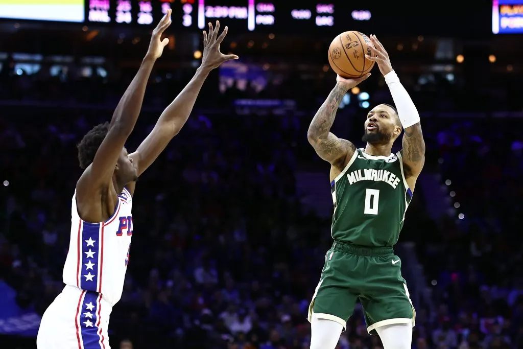 Damian Lillard #0 of the Milwaukee Bucks shoots over Mo Bamba #5 of the Philadelphia 76ers. Tim Nwachukwu/Getty Images