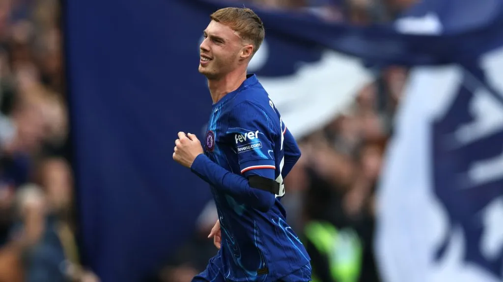 Cole Palmer of Chelsea celebrates scoring his team’s third goal and his hat trick during the Premier League match between Chelsea FC and Brighton & Hove Albion FC at Stamford Bridge on September 28, 2024 in London, England.