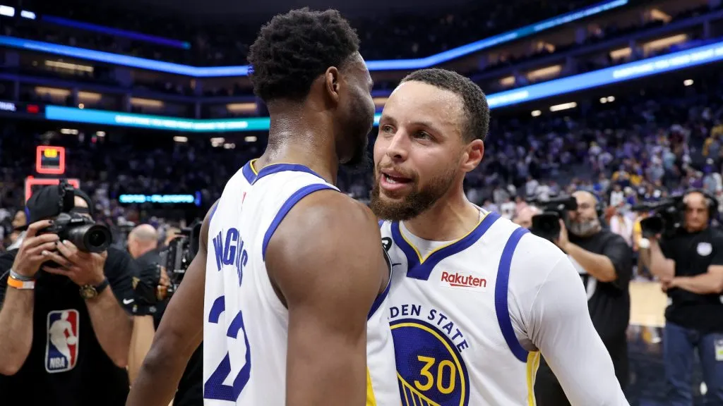 Stephen Curry #3 and Andrew Wiggins #22 of the Golden State Warriors celebrate after they beat the Sacramento Kings in Game Five of the Western Conference First Round Playoffs at Golden 1 Center on April 26, 2023 in Sacramento, California. (Photo by Ezra Shaw/Getty Images)