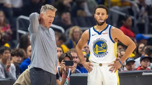 Golden State Warriors head coach Steve Kerr talks with Golden State Warriors guard Stephen Curry (30) courtside during a break in the first half