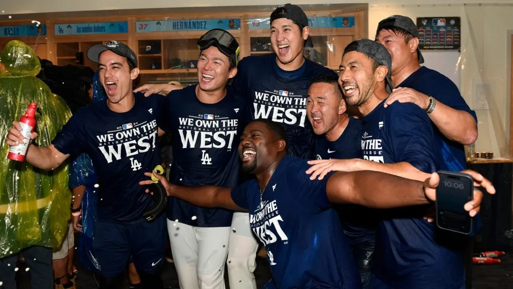 Shohei Ohtani #17, Yoshinobu Yamamoto #18 and the train staff of the Los Angeles Dodgers celebrate after winning the NL West Division against the San Diego Padres at Dodger Stadium on September 26, 2024 in Los Angeles, California. (Photo by Kevork Djansezian/Getty Images)