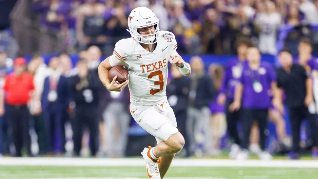 Texas quarterback Quinn Ewers (3) runs with the ball during NCAA football game action between the Texas Longhorns and the Washington Huskies at Caesars Superdome in New Orleans, Louisiana.