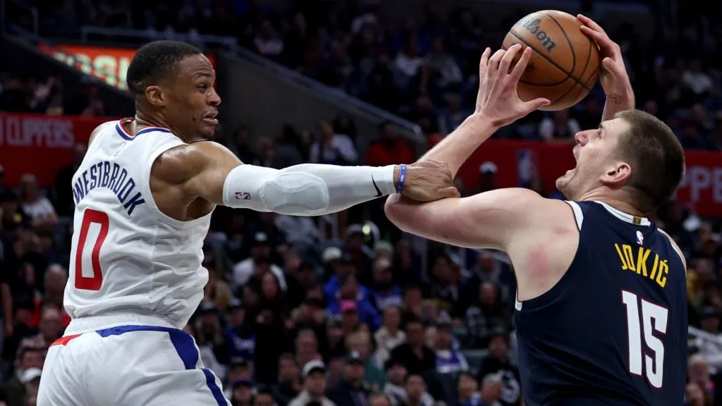 Nikola Jokic #15 of the Denver Nuggets reacts as he is fouled by Russell Westbrook #0 of the LA Clippers during a 102-100 Clippers win at Crypto.com Arena. (Photo by Harry How/Getty Images)