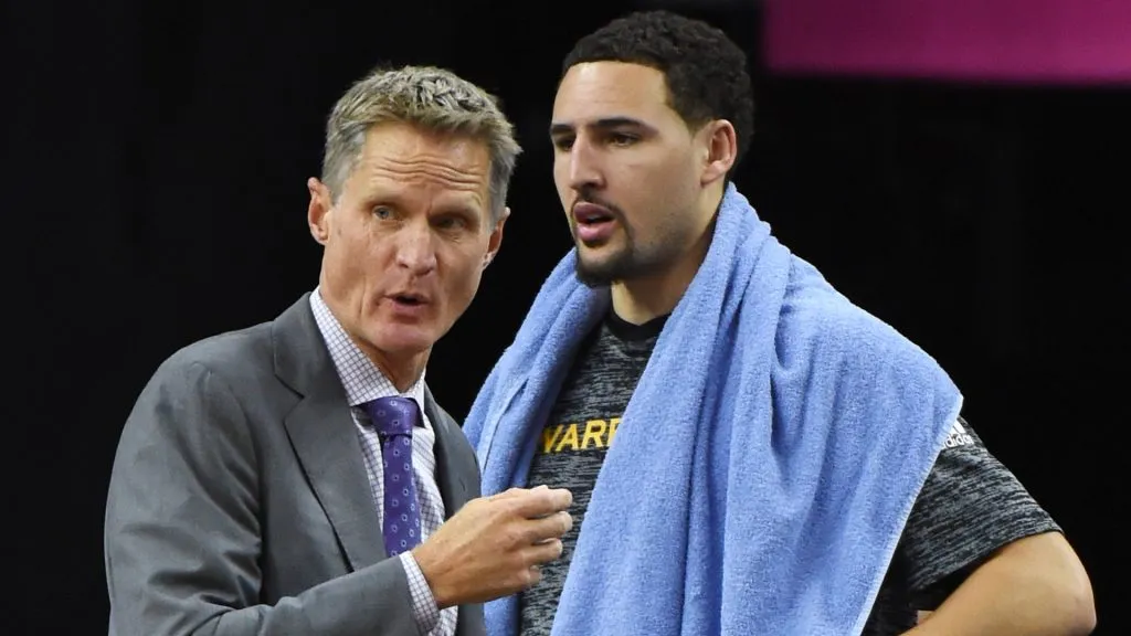 Head coach Steve Kerr of the Golden State Warriors talks to Klay Thompson #11 on the bench during their preseason game against the Los Angeles Lakers. Ethan Miller/Getty Images