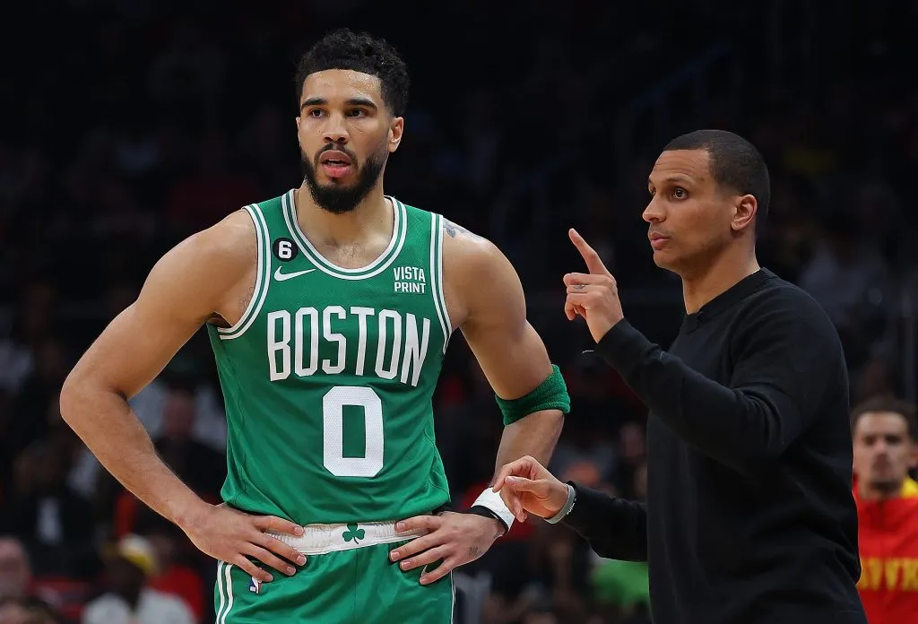 Head coach Joe Mazzulla of the Boston Celtics converses with Jayson Tatum #0. Kevin C. Cox/Getty Images