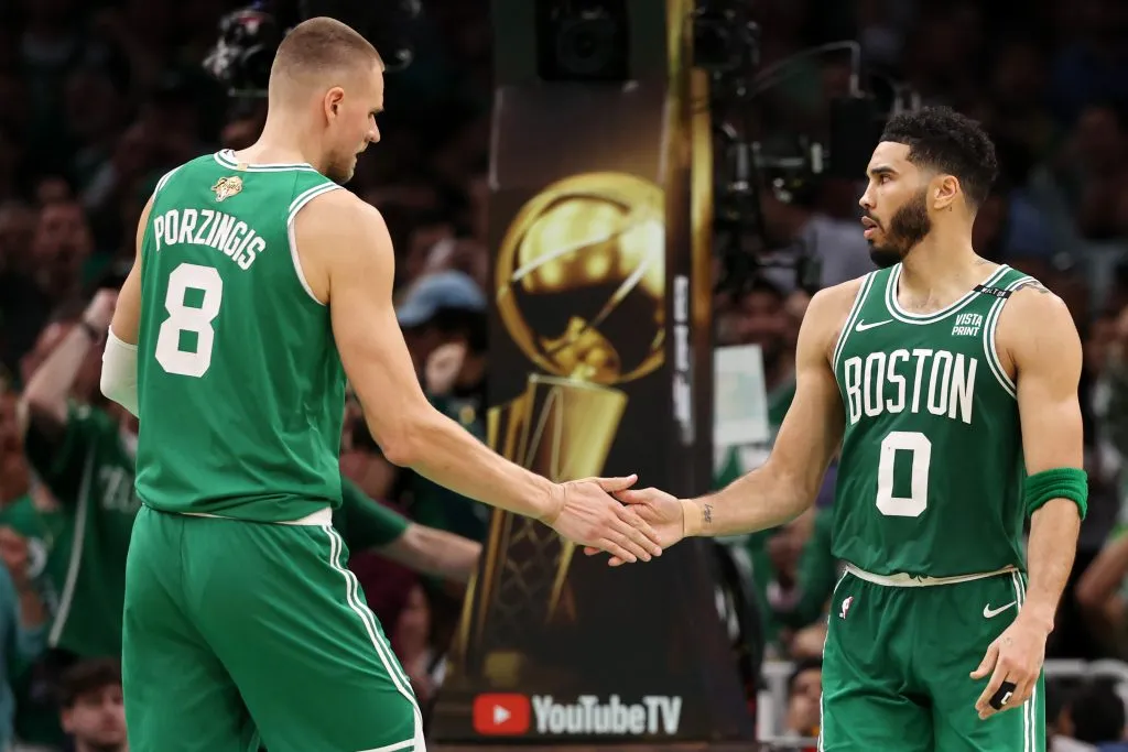 Kristaps Porzingis #8 high fives Jayson Tatum #0 of the Boston Celtics after a play against the Dallas Mavericks. Elsa/Getty Images