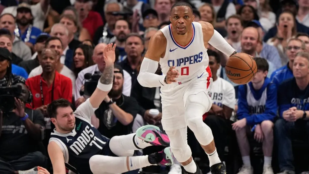 Russell Westbrook #0 of the Los Angeles Clippers handles the ball in front of Luka Doncic #77 of the Dallas Mavericks during the first half of game three of the Western Conference First Round Playoffs at American Airlines Center on April 26, 2024 in Dallas, Texas. (Photo by Sam Hodde/Getty Images)