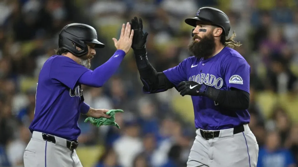 Jake Cave #11 of the Colorado Rockies congratulates Charlie Blackmon on his home run in the ninth inning against the Los Angeles Dodgers at Dodger Stadium. (Photo by John McCoy/Getty Images)