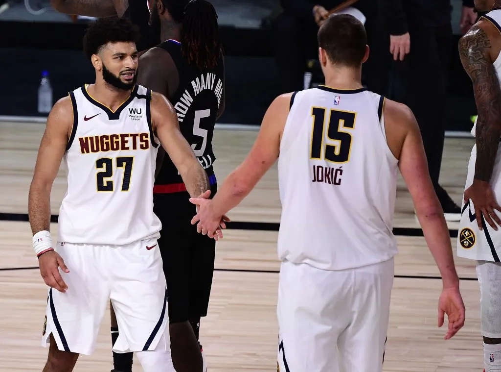 Jamal Murray #27 of the Denver Nuggets and Nikola Jokic #15 of the Denver Nuggets react during the third quarter against the LA Clippers. Douglas P. DeFelice/Getty Images