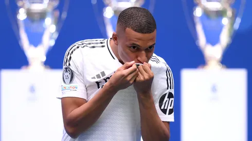 Real Madrid new signing, Kylian Mbappe kisses the Real Madrid badge as he is unveiled at Estadio Santiago Bernabeu on July 16, 2024 in Madrid, Spain.