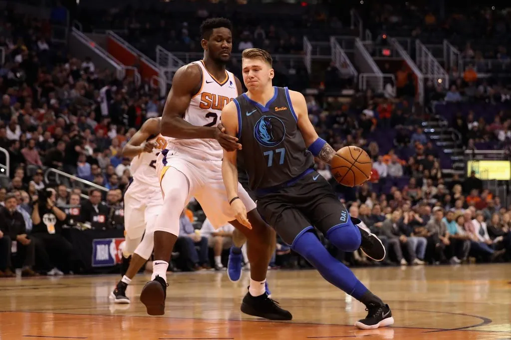Luka Doncic #77 of the Dallas Mavericks drives the ball past Deandre Ayton #22 of the Phoenix Suns during the NBA game. Christian Petersen/Getty Images